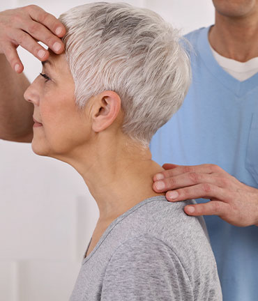 Patient receiving chiropractic adjusmtent for migraine relief from Buckeye Chiropractors