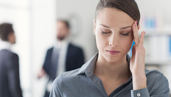 Woman with migraine needing a Buckeye chiropractor