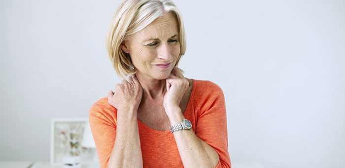 Mature woman suffering from neck and shoulder pain before visiting Buckeye chiropractor