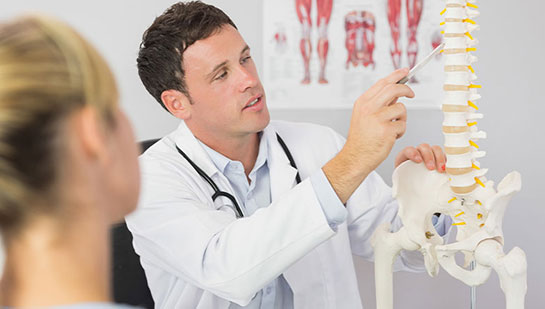 Buckeye chiropractor explaining spine misalignments to patient