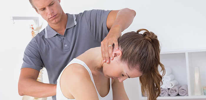 Woman receiving chiropractic adjustment from a Goodyear chiropractor