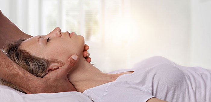 Woman receiving neck adjustment from Laveen chiropractor